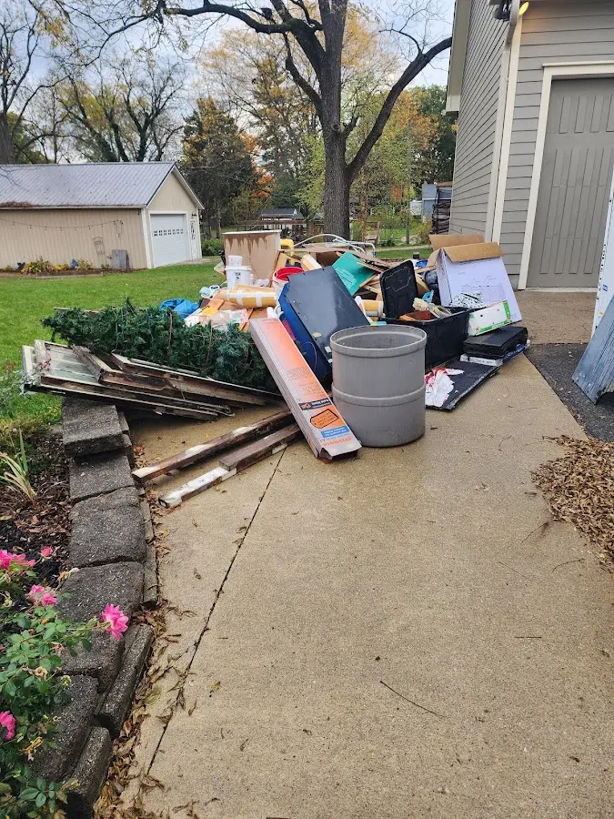 Dumpster being loaded with debris for Roofing Dumpster Rental in Cottleville